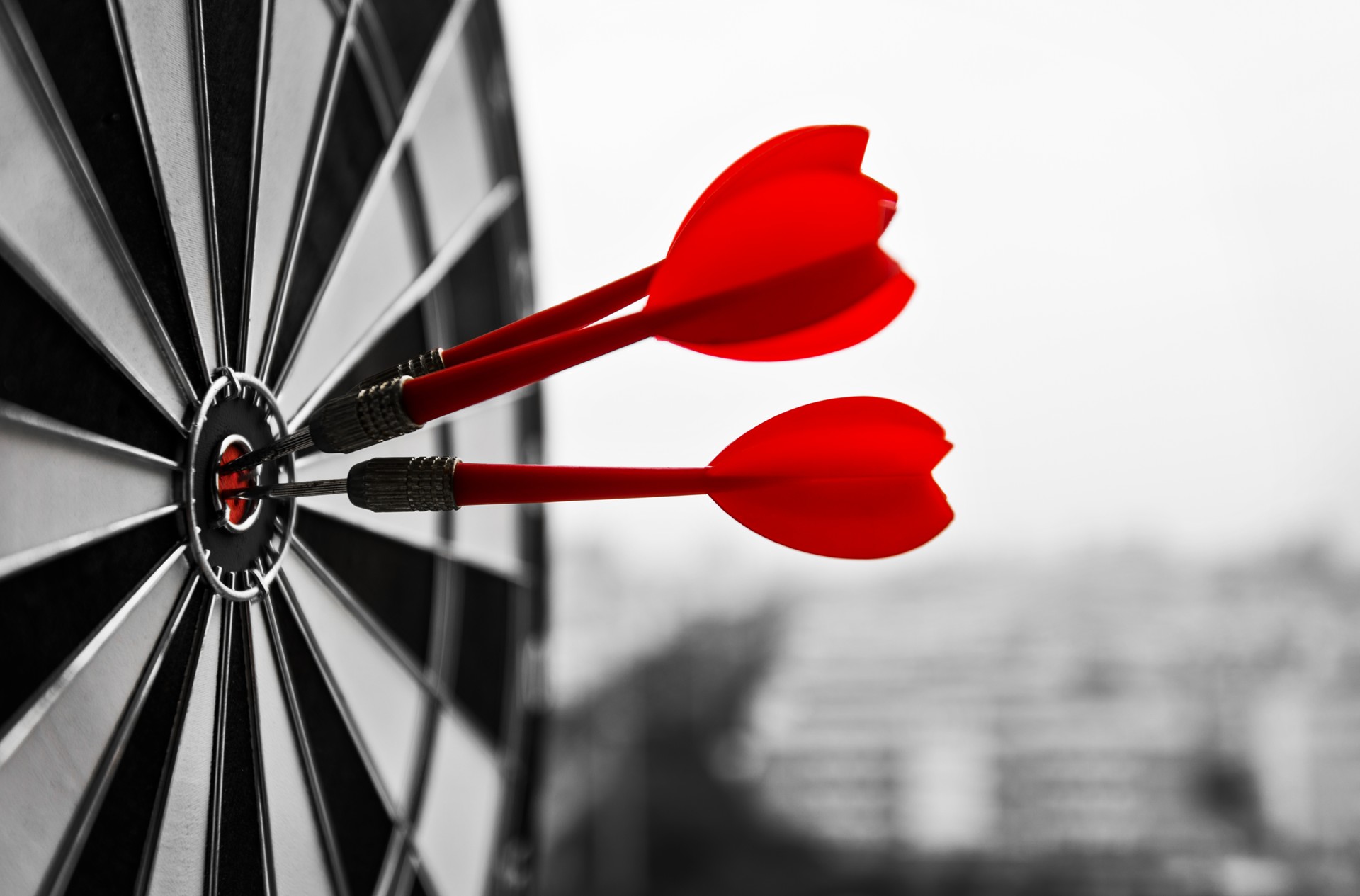 Dart board with three darts outdoors